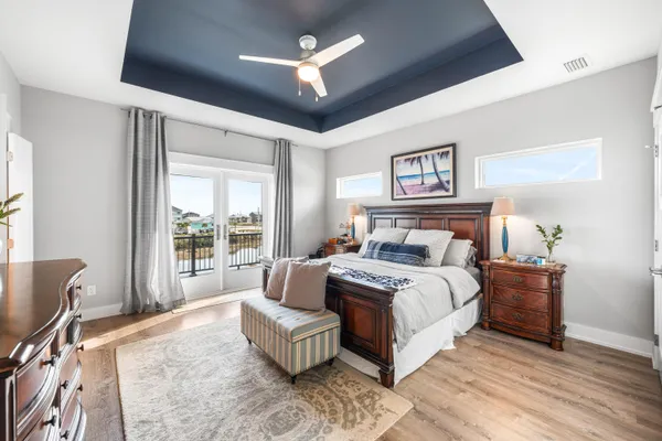 a view of a balcony with wooden floor next to a lake