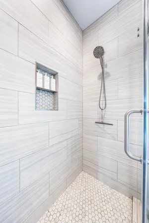 a bathroom with a sink toilet vanity and shower