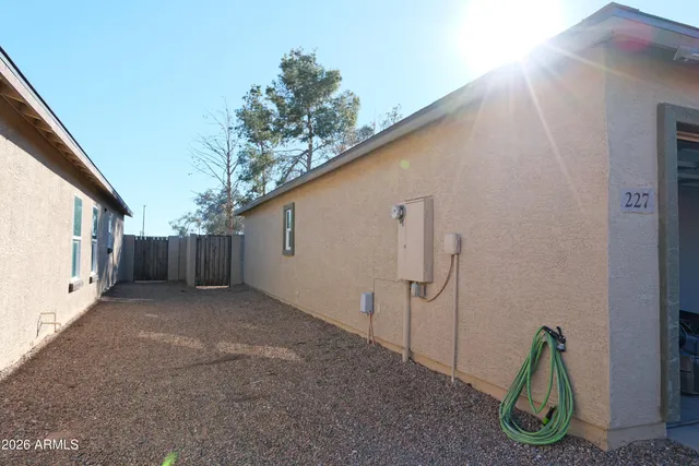 a view of a house with backyard and a trees