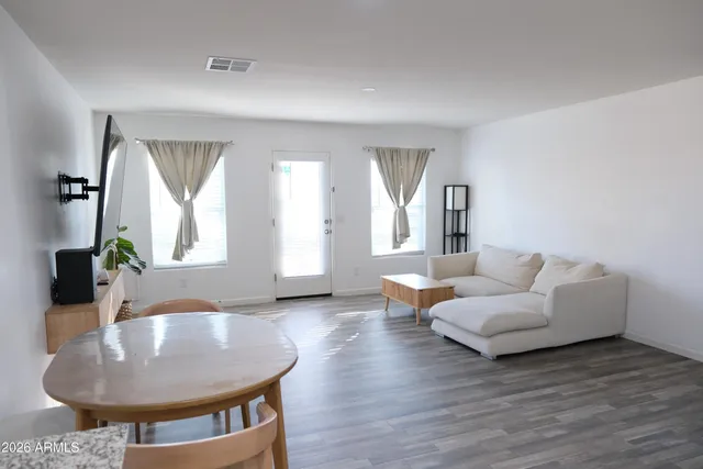 a living room with furniture and a potted plant