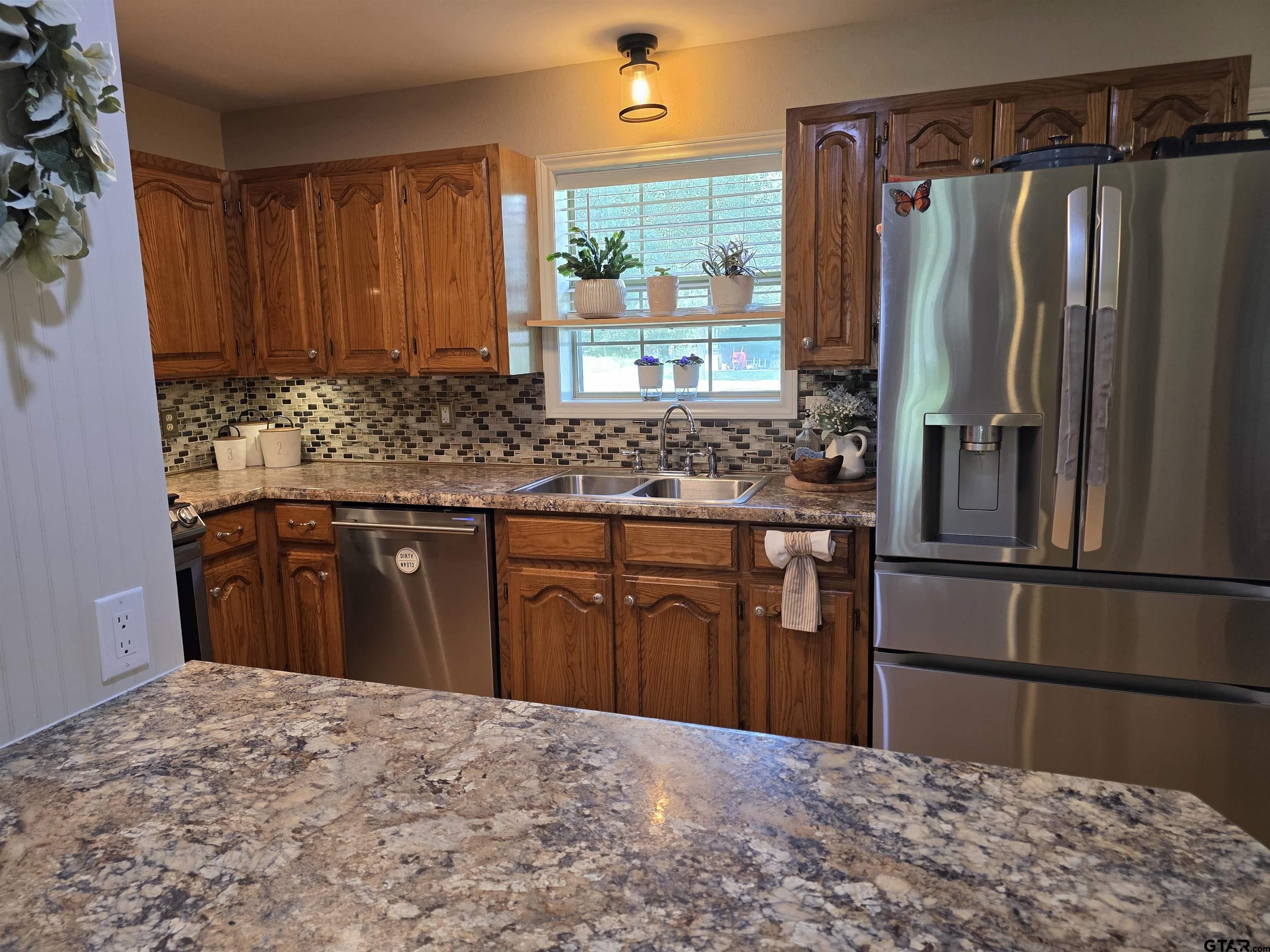 6170 Highway 271 Mount Pleasant, TX 75455 - Photo 18 of 43 a kitchen with stainless steel appliances granite countertop a refrigerator stove and sink