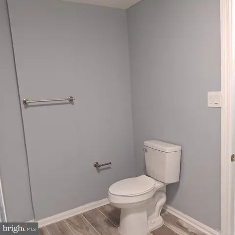 a white toilet sitting next to a shower