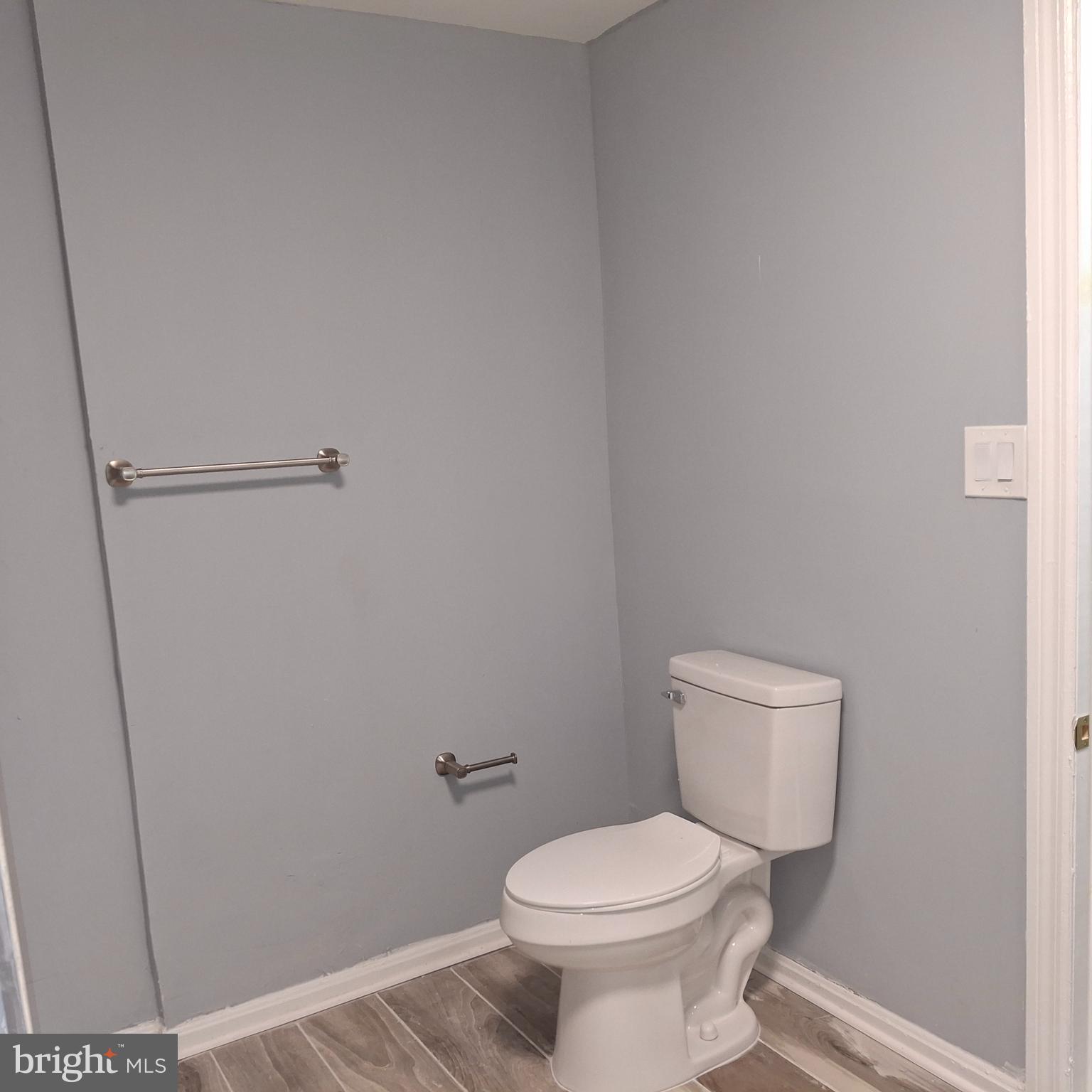 1403 Ramsay Street Baltimore, MD 21223 - Photo 22 of 30 a white toilet sitting next to a shower