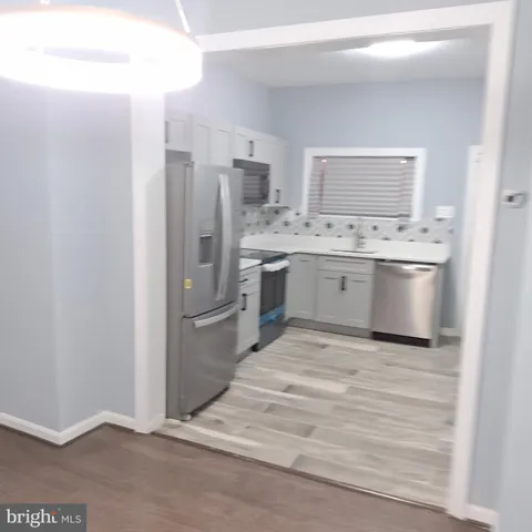 a kitchen with stainless steel appliances granite countertop a refrigerator and a stove