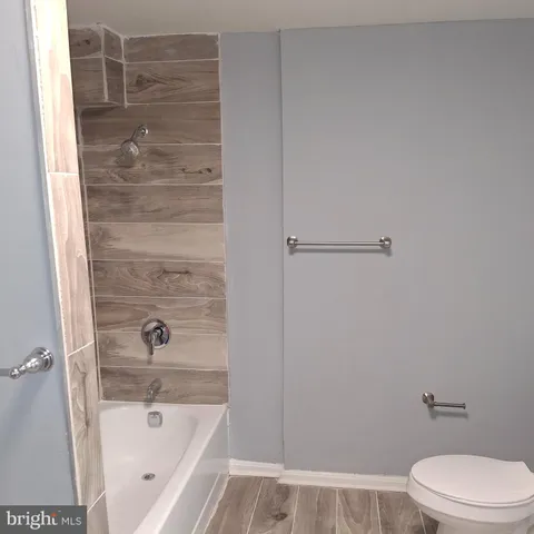 a bathroom with a bathtub and a toilet