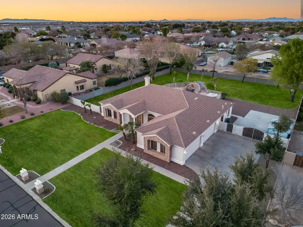 an aerial view of a house with a garden and lake view