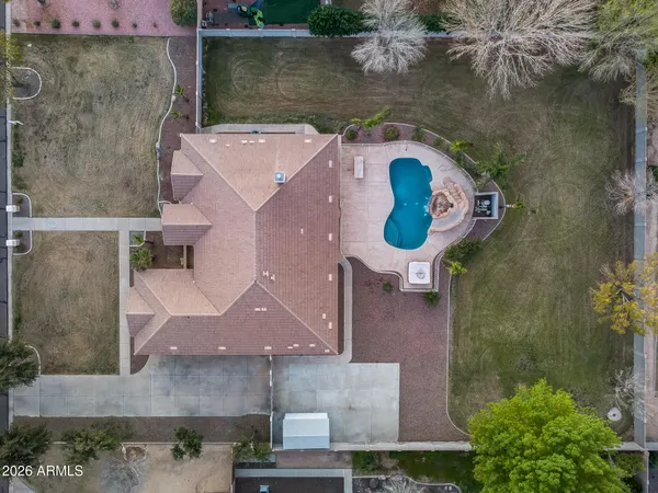 a aerial view of a house with backyard and outdoor seating