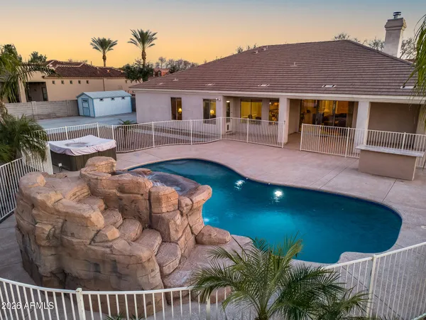 a view of a big house with a yard and large tree