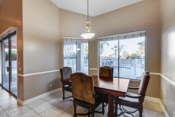 a kitchen with stainless steel appliances granite countertop a stove a sink dishwasher a refrigerator a microwave oven with white cabinets and wooden floor