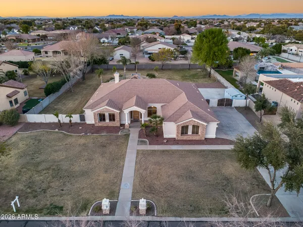 an aerial view of a house with a garden and trees