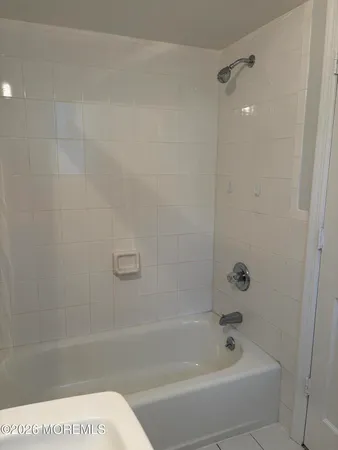a bathroom with a bathtub and shower