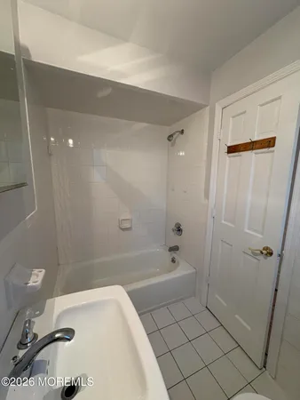 a bathroom with a bathtub a toilet and a shower