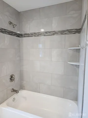 a bathroom with a tub and a shower