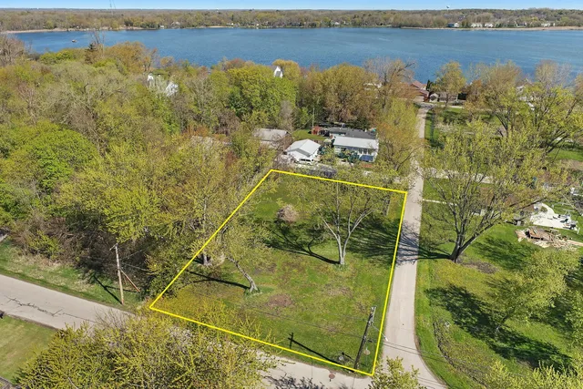 a aerial view of a residential houses with outdoor space and trees