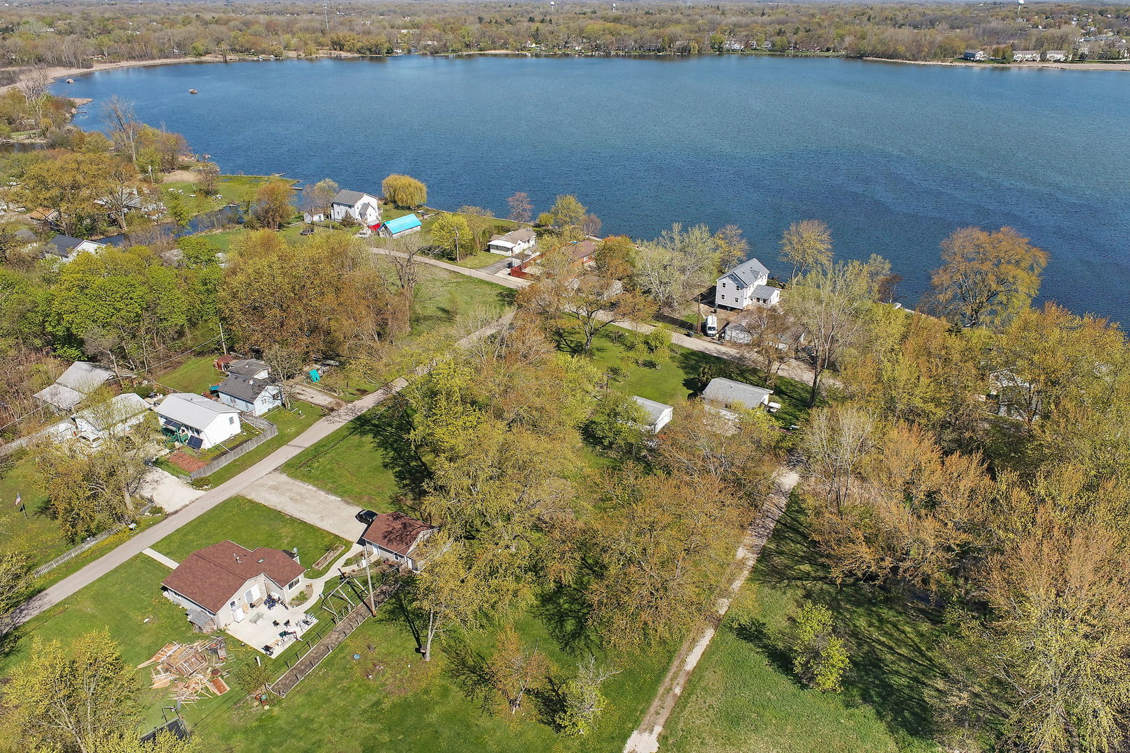 28490 West Main Street Wauconda, IL 60084 - Photo 2 of 4 a blue white and yellow flowers sitting in the middle of a lake