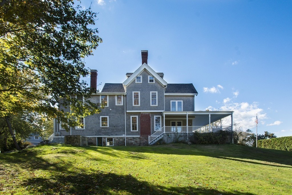 720 Jerusalem Road Cohasset, MA 02025 - Photo 12 of 29 a front view of a house with a yard table and chairs