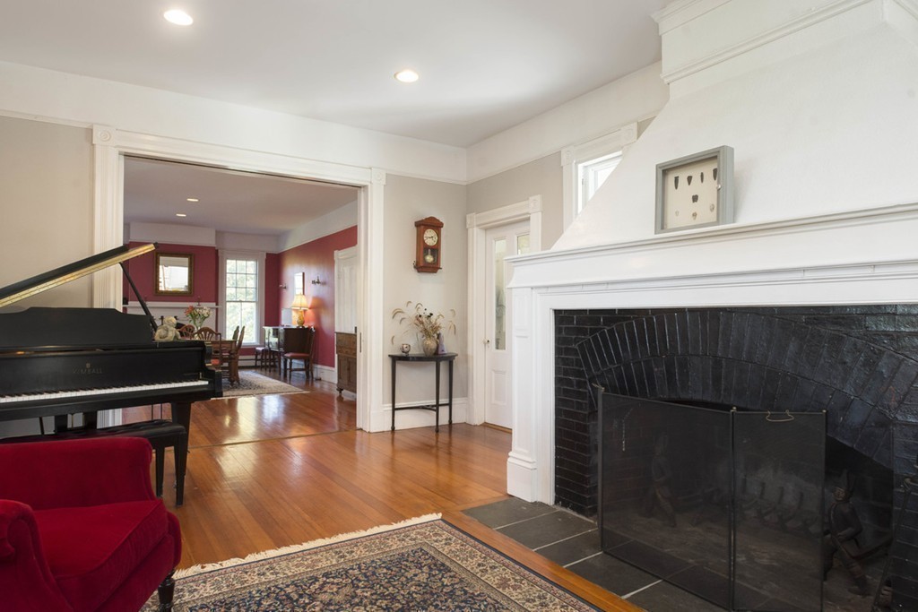 720 Jerusalem Road Cohasset, MA 02025 - Photo 18 of 29 a living room with furniture a dining table and a fireplace