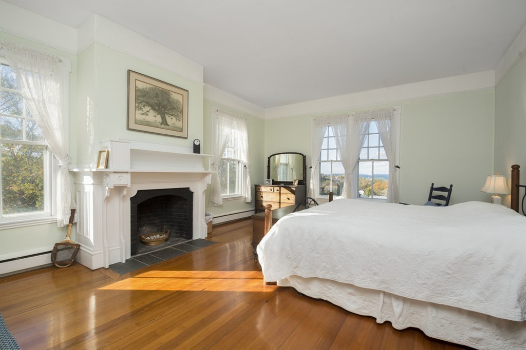 720 Jerusalem Road Cohasset, MA 02025 - Photo 23 of 29 a bedroom with a bed and a fireplace