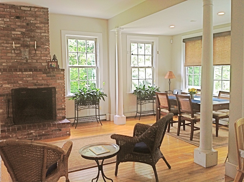 720 Jerusalem Road Cohasset, MA 02025 - Photo 7 of 29 a dining room with furniture a fireplace and wooden floor