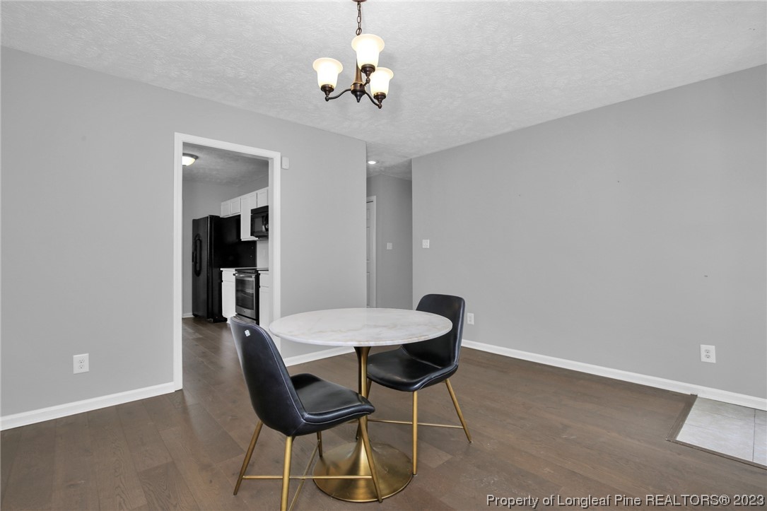 234 Cape Fear Road Raeford, NC 28376 - Photo 12 of 33 a view of a dining room with furniture and chandelier