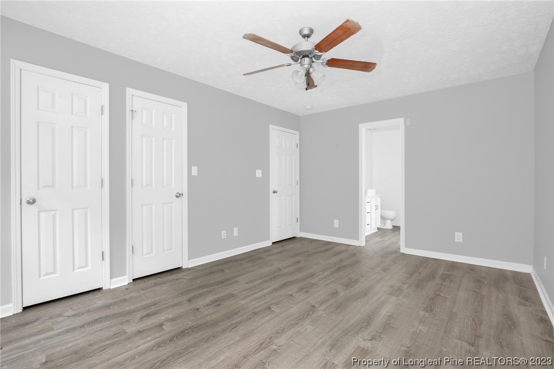 234 Cape Fear Road Raeford, NC 28376 - Photo 16 of 33 an empty room with wooden floor and ceiling fan