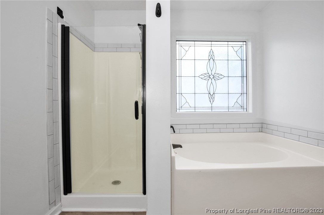234 Cape Fear Road Raeford, NC 28376 - Photo 18 of 33 a white bath tub sitting next to a window