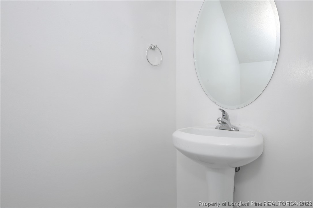 234 Cape Fear Road Raeford, NC 28376 - Photo 23 of 33 a bathroom with a sink and a mirror