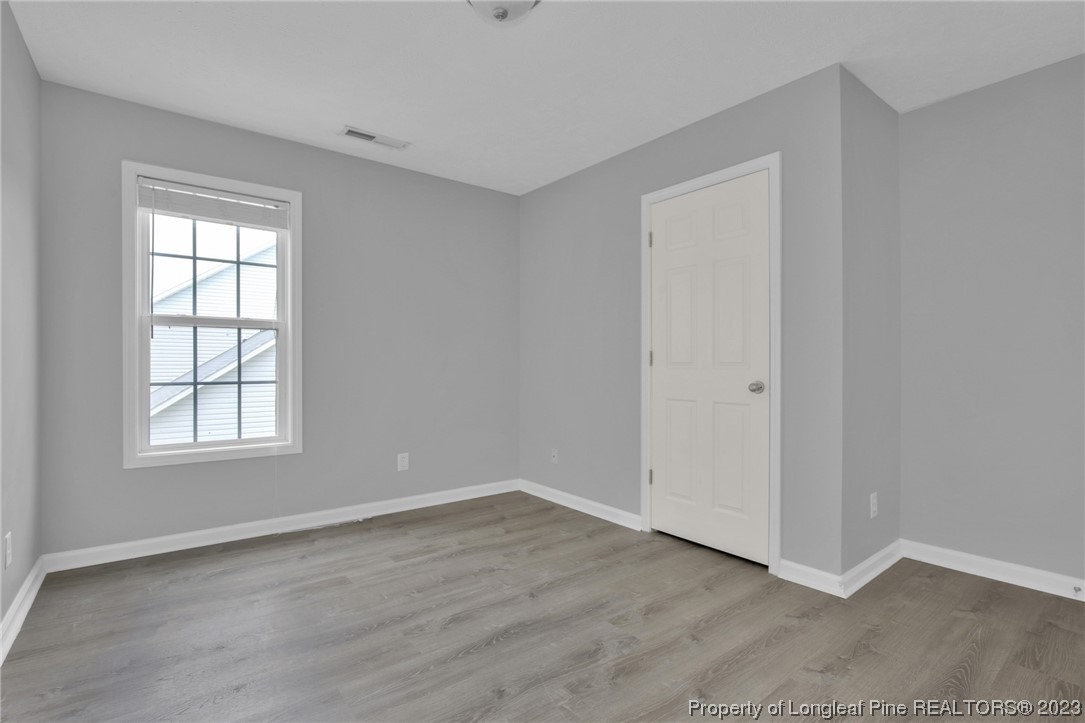 234 Cape Fear Road Raeford, NC 28376 - Photo 24 of 33 an empty room with wooden floor and windows