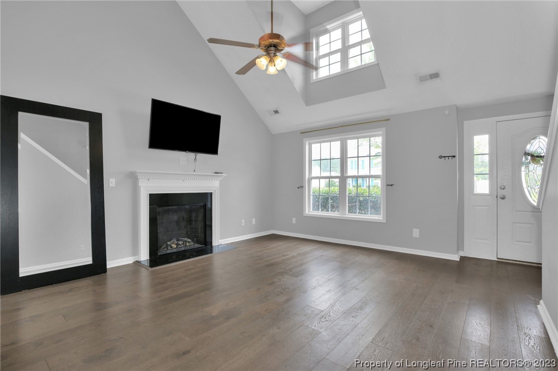 234 Cape Fear Road Raeford, NC 28376 - Photo 6 of 33 a view of an empty room with wooden floor fireplace and a window