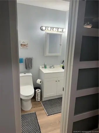 a bathroom with a sink toilet and mirror