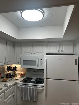 a kitchen with a refrigerator a stove a sink and a stove