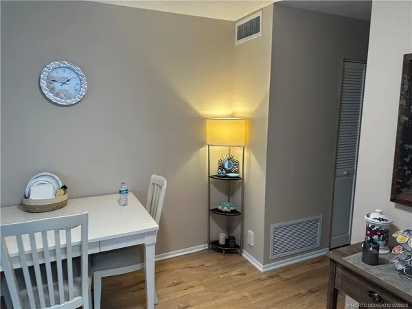 a view of workspace with furniture and wooden floor