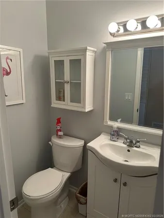 a bathroom with a sink mirror toilet and vanity