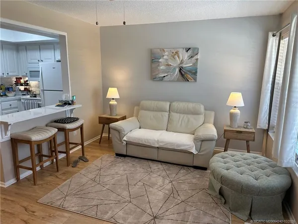 a living room with furniture and a lamp