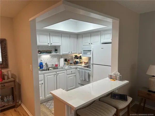 a kitchen with a sink a stove and refrigerator