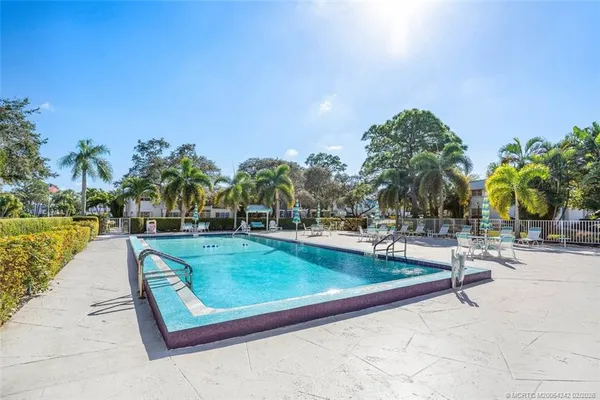 swimming pool with outdoor seating and yard