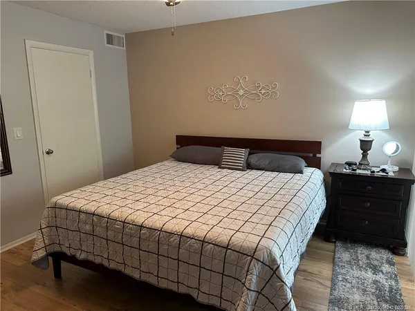 a bedroom with a bed and lamp