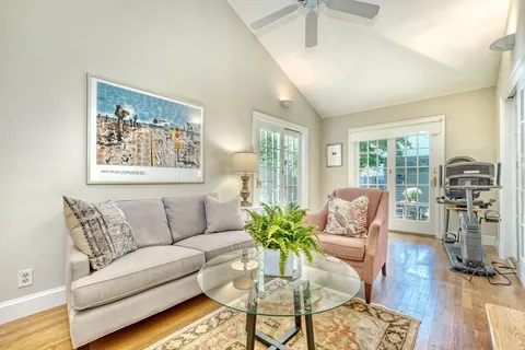 a living room with furniture and floor to ceiling windows