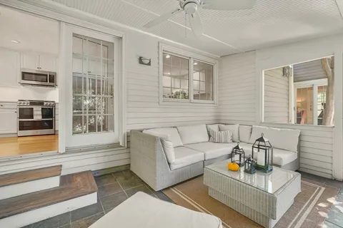a living room with furniture and floor to ceiling windows