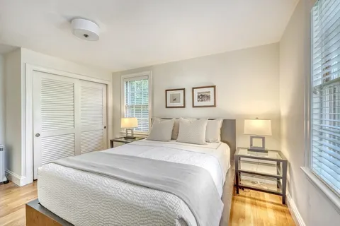 a bedroom with a bed and a night stand