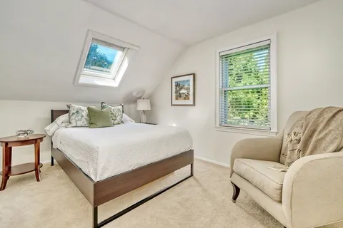 a bedroom with a bed couch and window