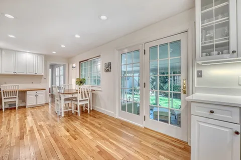 a view of a kitchen with dining room and wooden floor