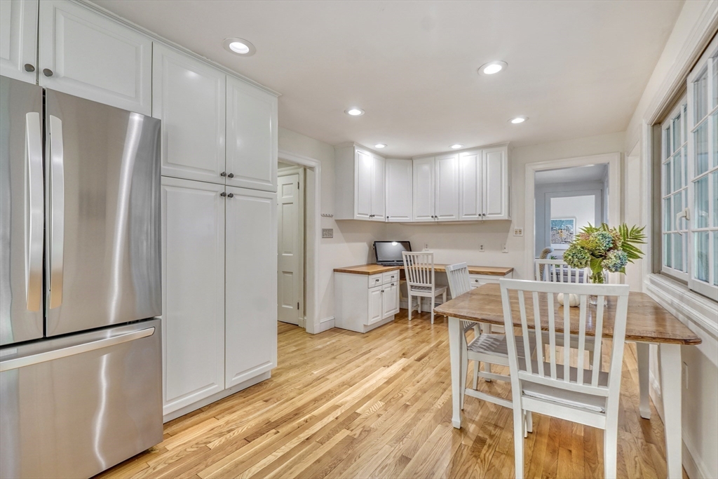 21 Philbrick Road Newton, MA 02459 - Photo 8 of 35 a kitchen with stainless steel appliances refrigerator dining table and chairs