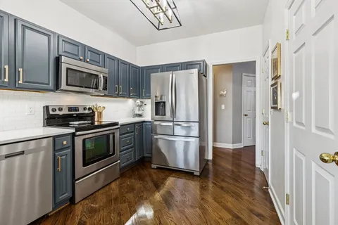 a kitchen with stainless steel appliances and wooden cabinets