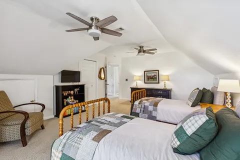 a bedroom with two beds and a chandelier