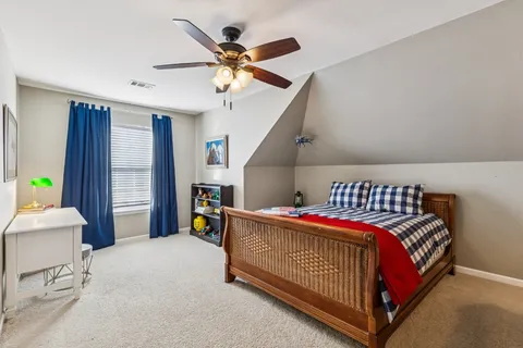 a bedroom with a bed and a chandelier
