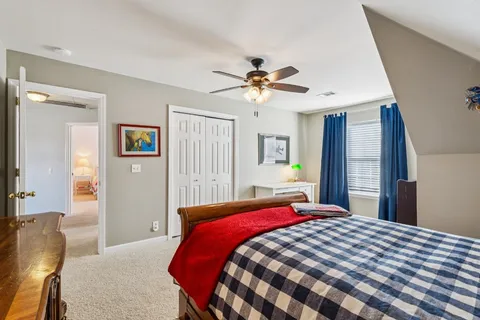 a bedroom with a large bed and a chandelier