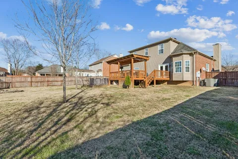 a view of a house with a yard covered with snow in the outdoor space