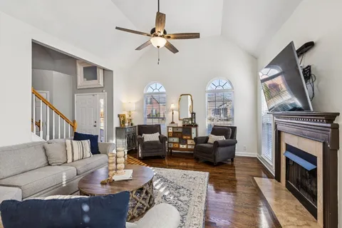 a living room with furniture a fireplace and a flat screen tv
