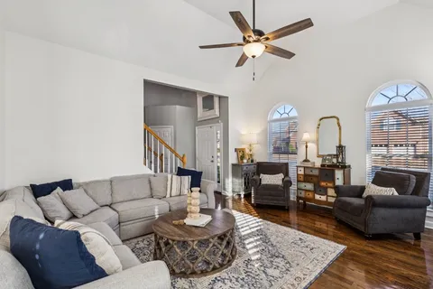 a living room with furniture and a chandelier